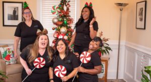 Group of dental professionals taking a holiday photo at their north Raleigh dental studio