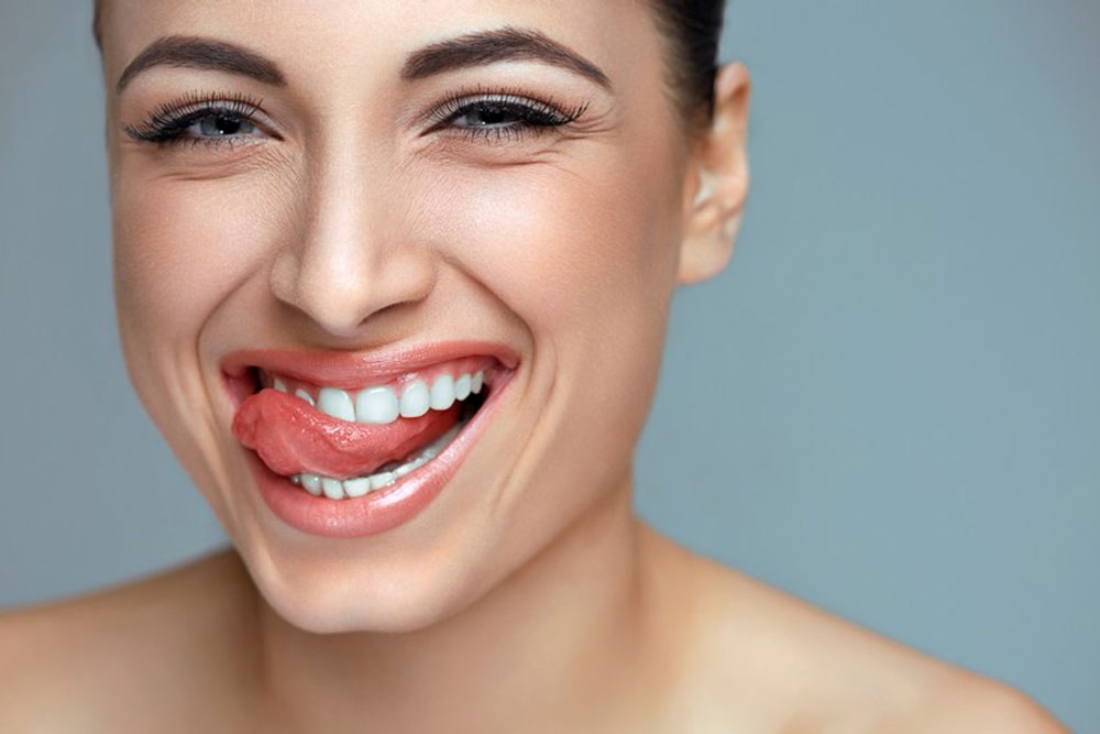 Woman showing off cosmetic dentistry services in Raleigh with a smile