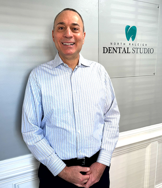 Raleigh-area dental professional, Dr. Gregg Festa Posing in Dental Office